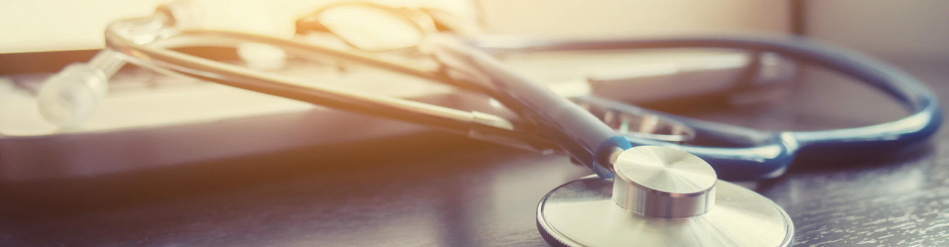 A stethoscope rests on a table in an office