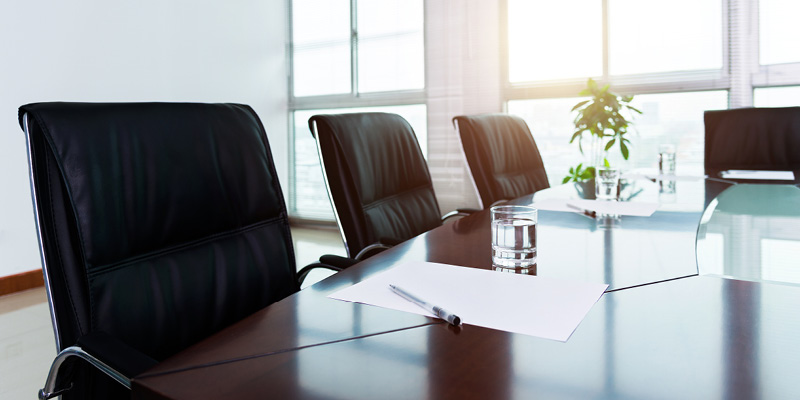Empty boardroom with chairs and meeting materials