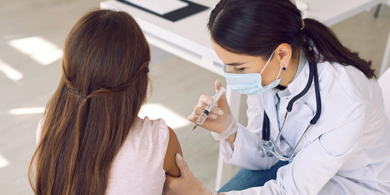 Doctor giving a vaccine to a young patient
