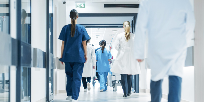 Medical staff walking through a hospital hallway